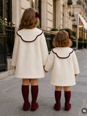 The 'Heritage'  ivory boucle coat with burgundy